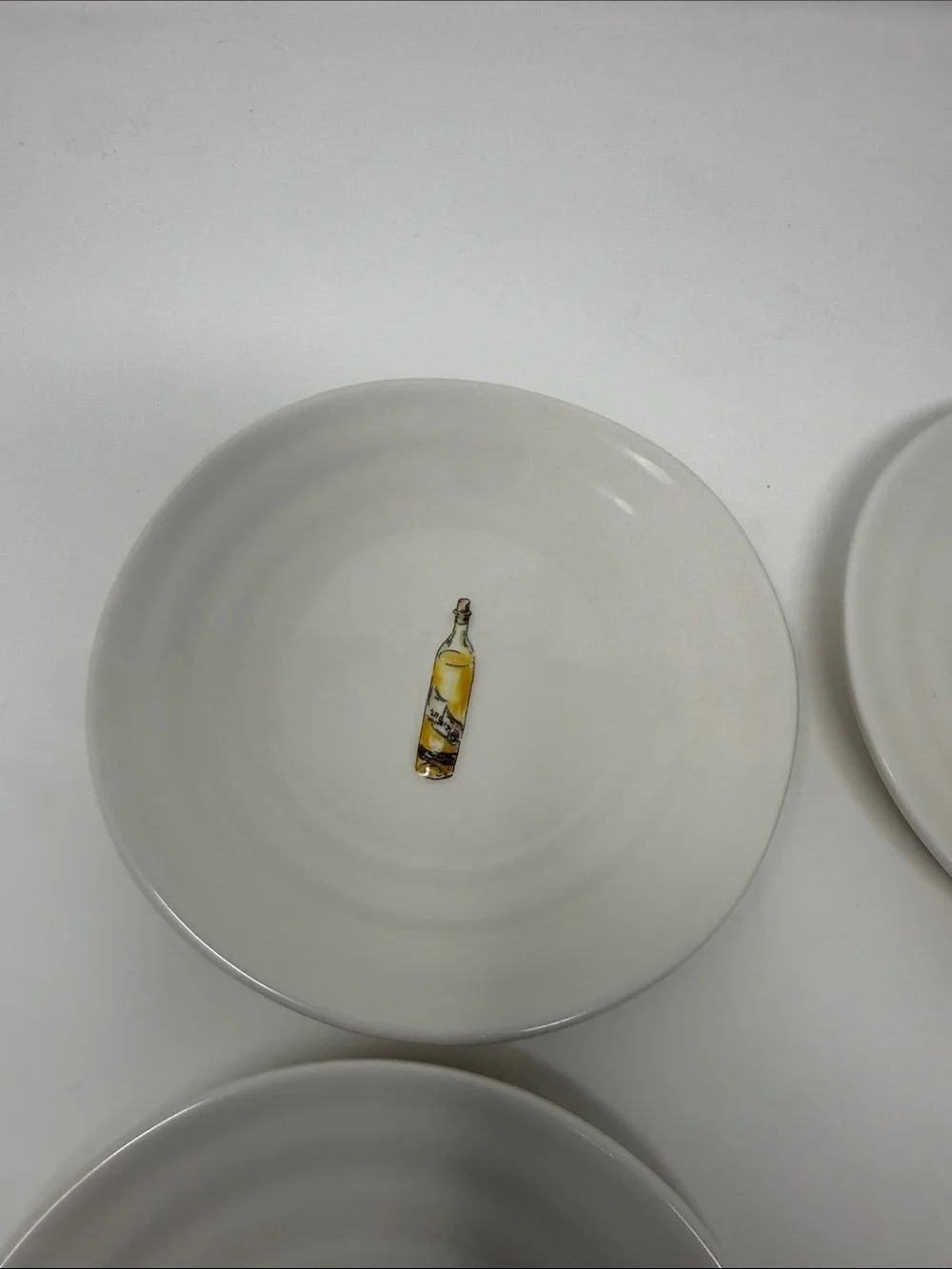 Williams Sonoma Cream Ceramic Dinner Plates with Wine Bottle Motifs - Set of 4
